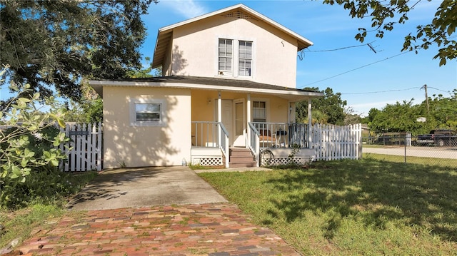 view of front of home featuring a front lawn and a porch