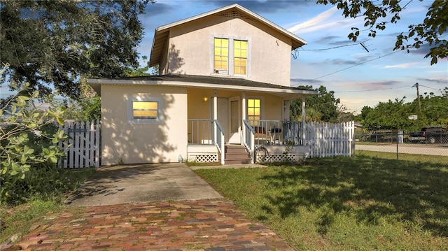 view of front facade with covered porch and a front yard