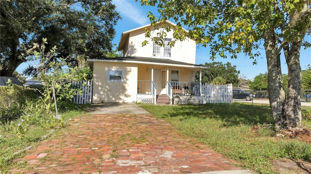 farmhouse inspired home featuring covered porch and a front lawn