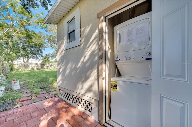 laundry area with stacked washer / drying machine