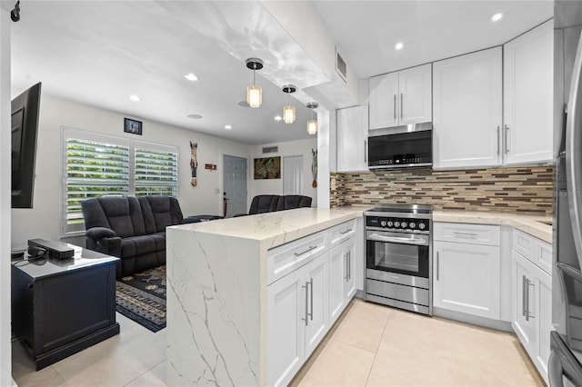 kitchen with kitchen peninsula, pendant lighting, white cabinetry, appliances with stainless steel finishes, and light stone counters