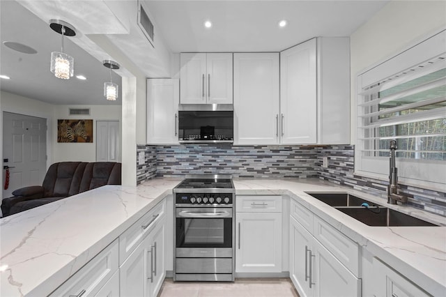 kitchen featuring tasteful backsplash, appliances with stainless steel finishes, sink, hanging light fixtures, and white cabinetry