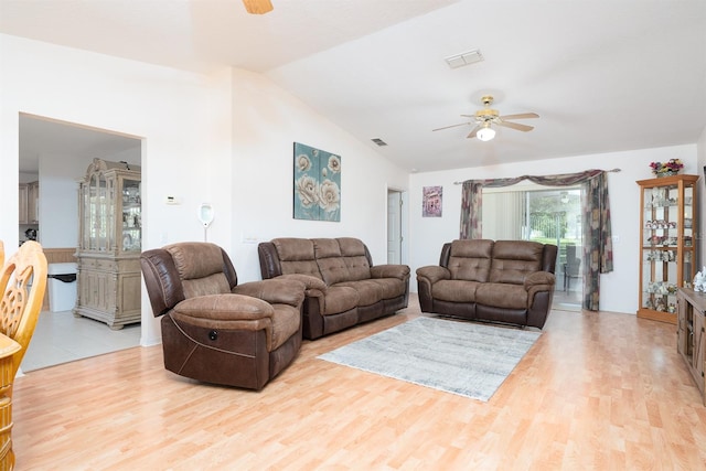 living room featuring light hardwood / wood-style floors, lofted ceiling, and ceiling fan