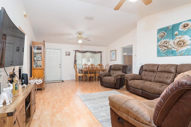 living room featuring light hardwood / wood-style floors, lofted ceiling, and ceiling fan