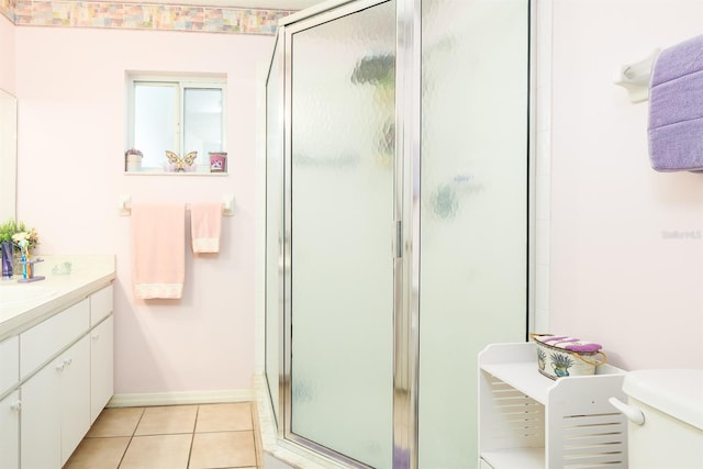 bathroom featuring vanity, toilet, tile patterned floors, and a shower with door