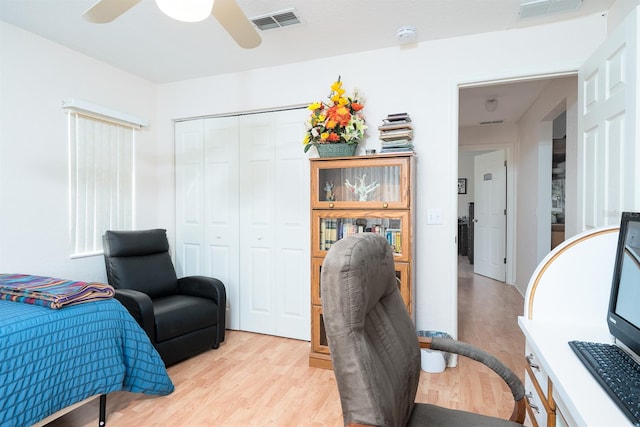 home office featuring light hardwood / wood-style floors and ceiling fan