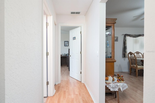 corridor featuring light hardwood / wood-style floors