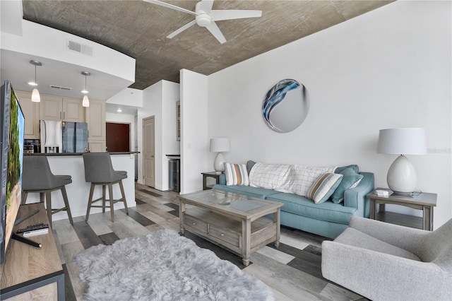 living room with light hardwood / wood-style flooring and ceiling fan