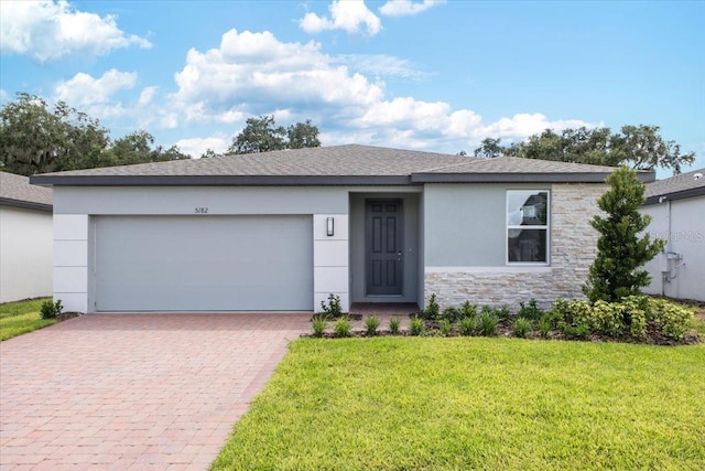 ranch-style house with a garage and a front lawn