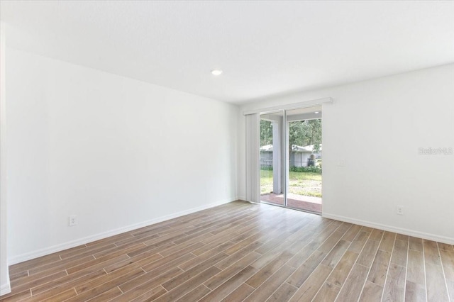 unfurnished room featuring hardwood / wood-style flooring