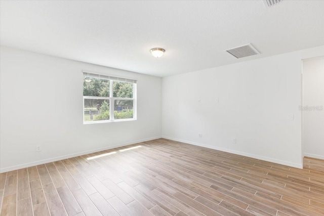 spare room featuring light wood-type flooring