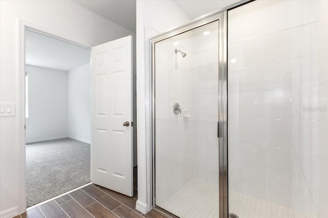 bathroom with a shower with door