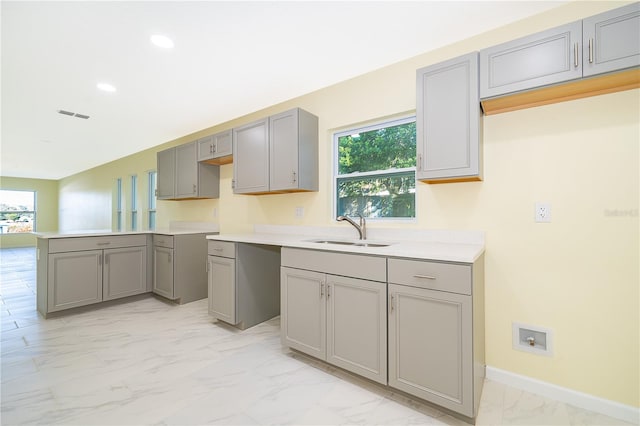 kitchen with gray cabinetry and sink