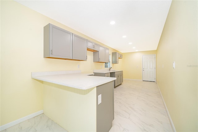 kitchen featuring gray cabinets, sink, and kitchen peninsula