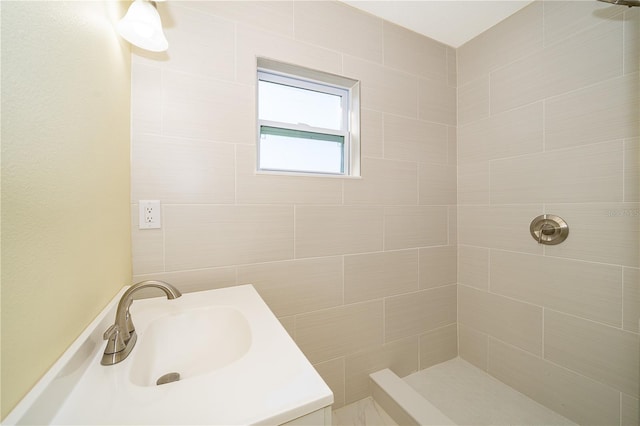 bathroom featuring vanity and a tile shower