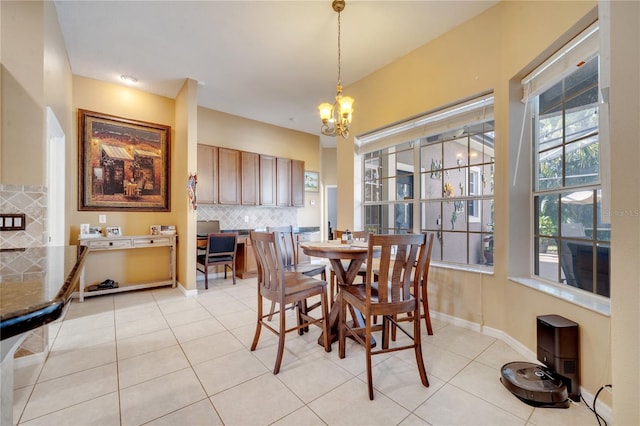 dining space featuring light tile patterned floors and an inviting chandelier