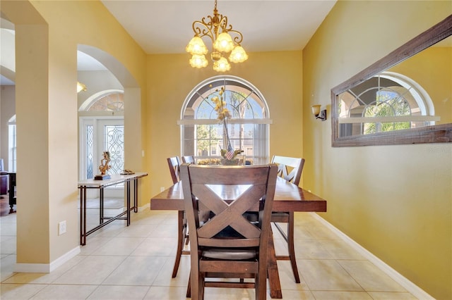 tiled dining room with a wealth of natural light and an inviting chandelier