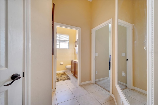 bathroom with tile patterned flooring, vanity, and toilet