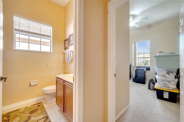 bathroom with ceiling fan, vanity, toilet, and tile patterned flooring