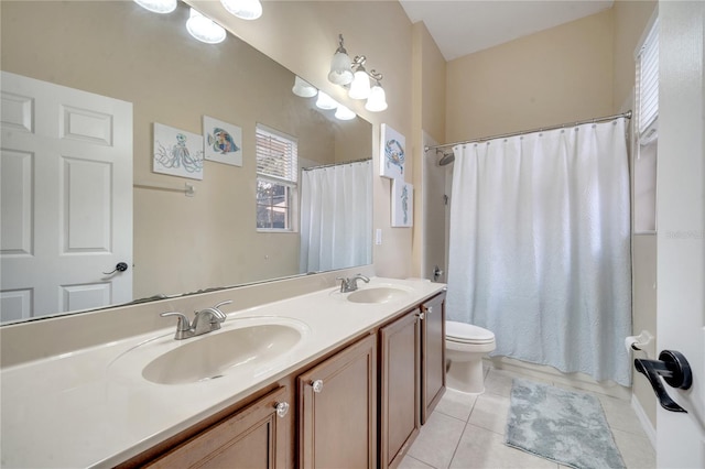 bathroom featuring vanity, tile patterned floors, and toilet