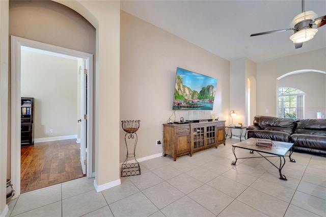 living room with ceiling fan and light wood-type flooring