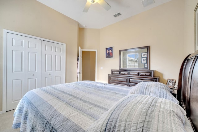 bedroom with a closet, light colored carpet, and ceiling fan