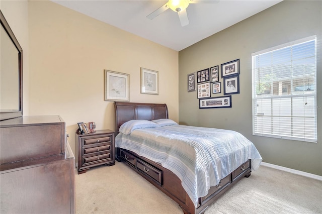 bedroom with ceiling fan and light carpet