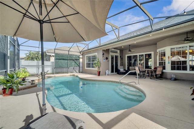 view of swimming pool featuring a lanai, ceiling fan, and a patio