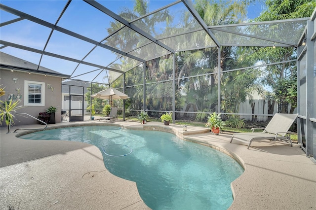 view of swimming pool featuring a lanai and a patio area