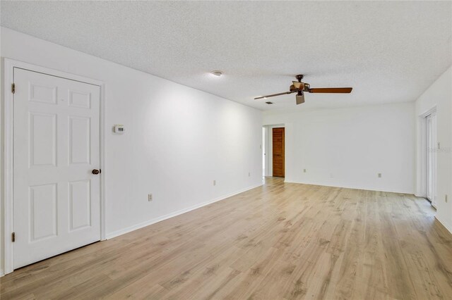 empty room with light wood-type flooring, a textured ceiling, and ceiling fan