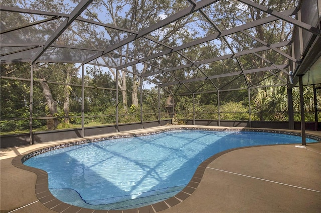 view of pool with glass enclosure and a patio