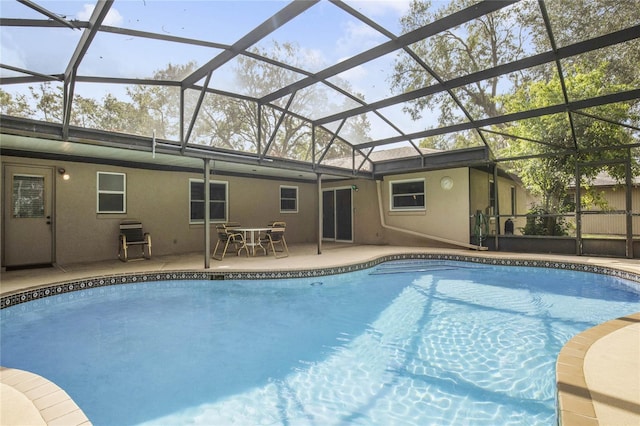 view of pool featuring a patio and glass enclosure