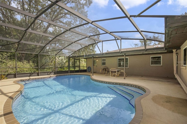 view of swimming pool featuring a patio and a lanai