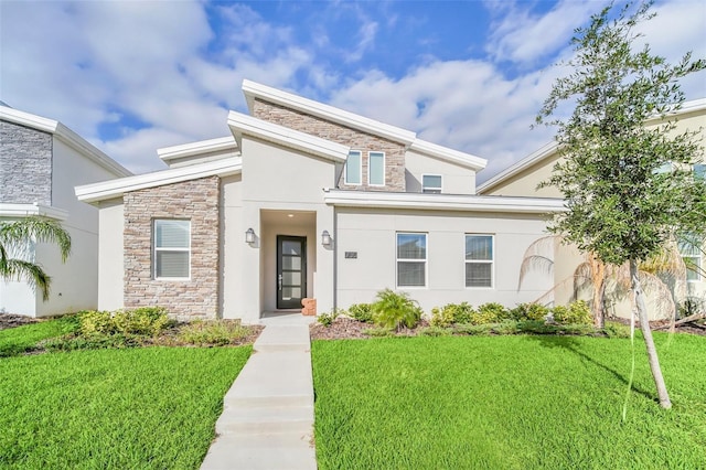 730 Drop Shot Dr, Davenport, FL 33896 - view of front of house with stone siding, a front lawn, and stucco siding