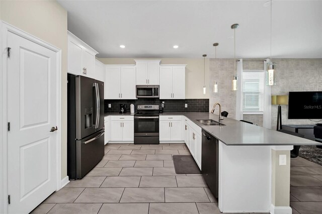 730 Drop Shot Dr, Davenport, FL 33896 - kitchen featuring stainless steel appliances, a sink, a peninsula, decorative backsplash, and white cabinets