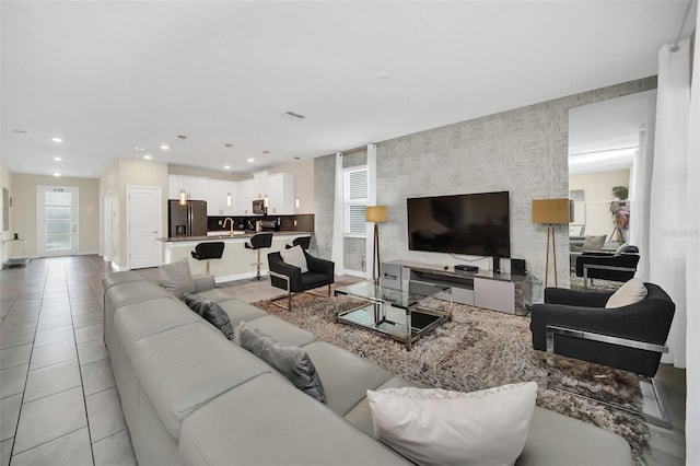 tiled living room featuring sink