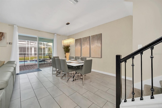 730 Drop Shot Dr, Davenport, FL 33896 - dining space featuring stairway, light tile patterned floors, and a chandelier