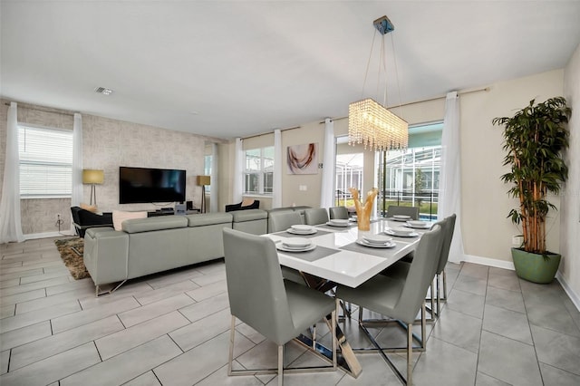 dining room featuring a chandelier and light tile patterned floors