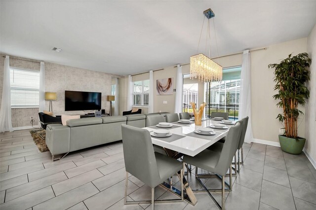 730 Drop Shot Dr, Davenport, FL 33896 - dining space with an accent wall, wallpapered walls, baseboards, and healthy amount of natural light