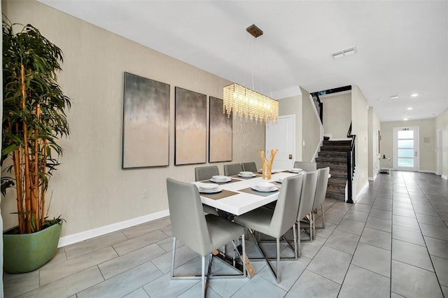 730 Drop Shot Dr, Davenport, FL 33896 - dining area with stairs, a chandelier, baseboards, light tile patterned flooring, and recessed lighting