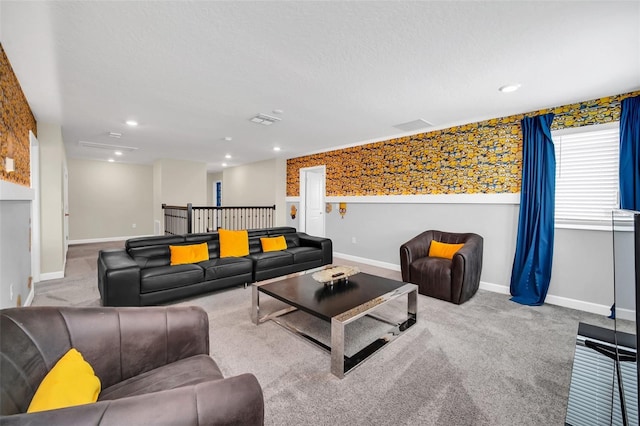 living room featuring a textured ceiling and light colored carpet