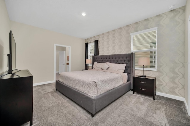 carpeted bedroom featuring multiple windows