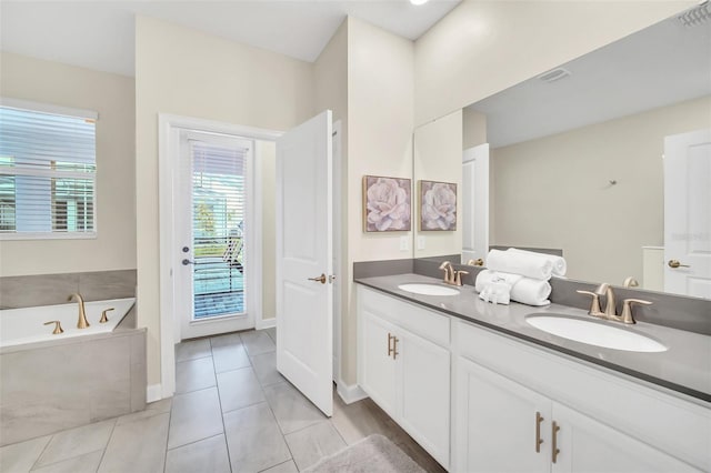 bathroom with vanity, a tub to relax in, and tile patterned floors