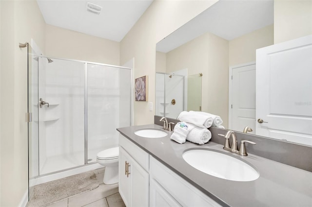 bathroom with vanity, toilet, walk in shower, and tile patterned flooring