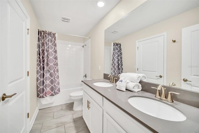 full bathroom featuring vanity, shower / bath combo with shower curtain, toilet, and tile patterned floors