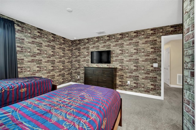 bedroom with brick wall and carpet flooring