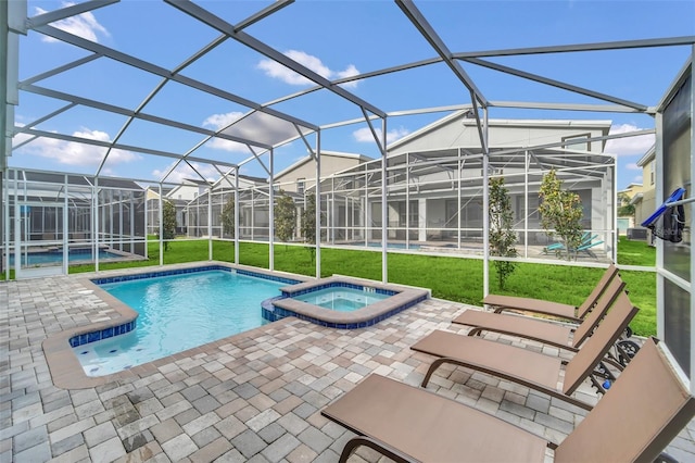 view of pool with a patio, an in ground hot tub, a lawn, and glass enclosure