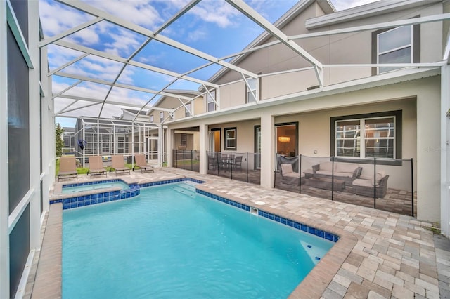 view of swimming pool with an in ground hot tub, a patio area, and a lanai