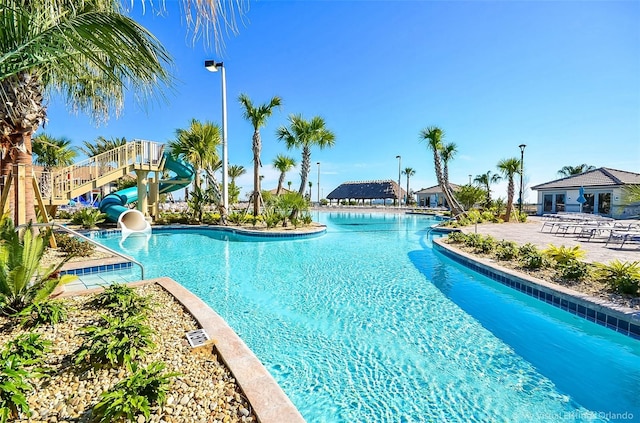 view of swimming pool featuring a patio and a water slide