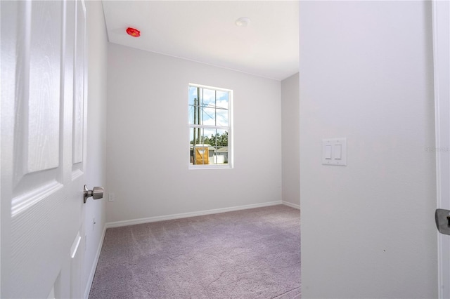 spare room with light colored carpet